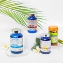 An elegant arrangement of health supplements on a white background with a tropical fern leaf.