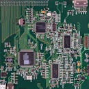 Detailed image of a green circuit board featuring various components and microprocessors.